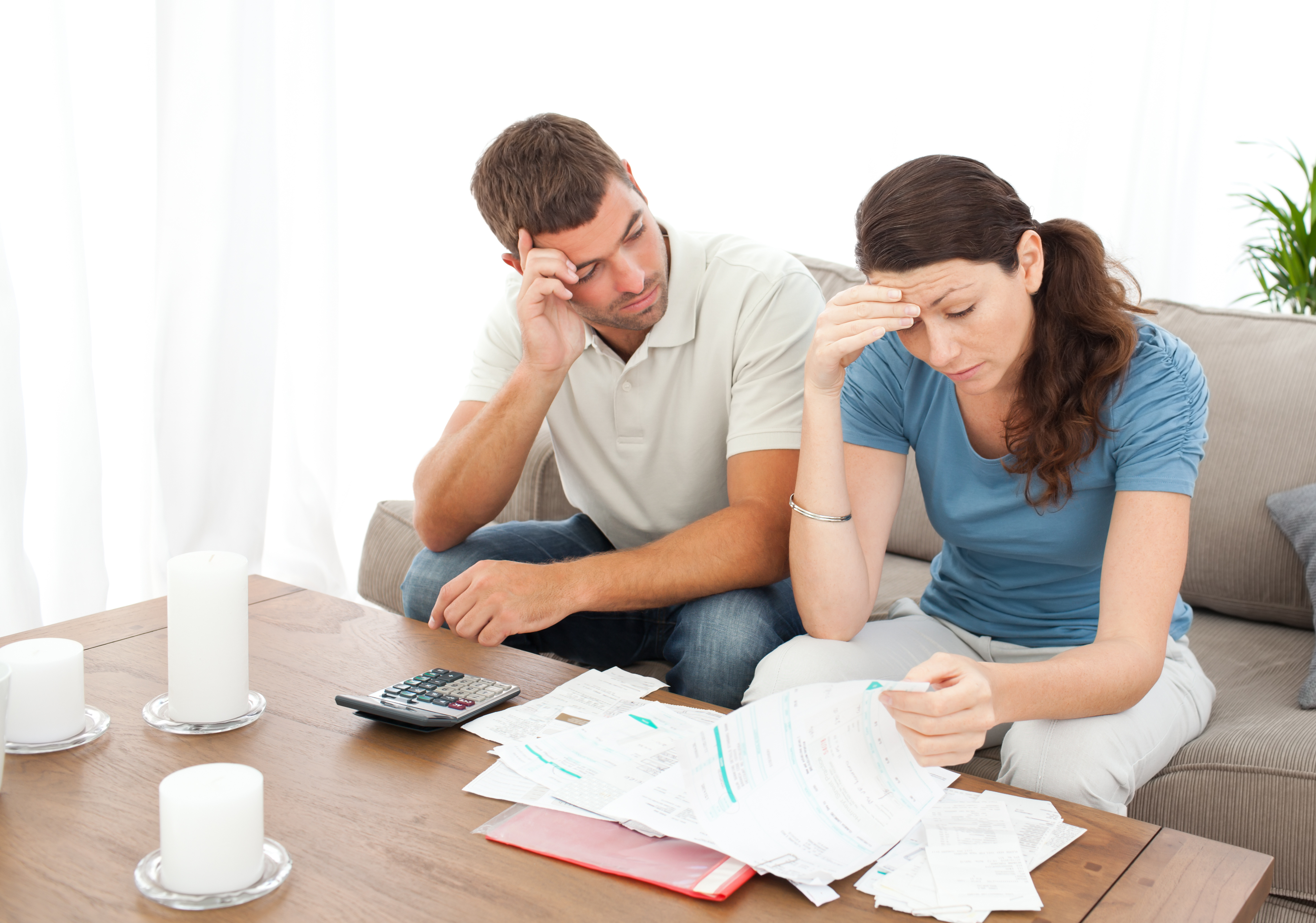 Worried couple doing their accounts in the living room